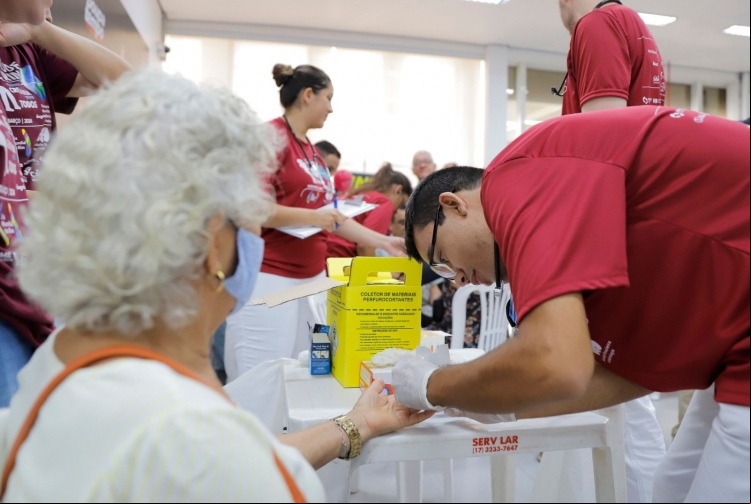 Legenda: Profissionais de saúde realizam exames gratuitos durante a campanha do Dia Mundial do Rim em São José do Rio Preto. A iniciativa visa detectar precocemente doenças renais e conscientizar a população sobre a importância da prevenção.